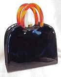 Snazzy black shiny vinyl handbag w tortoise Lucite horseshoe handles
